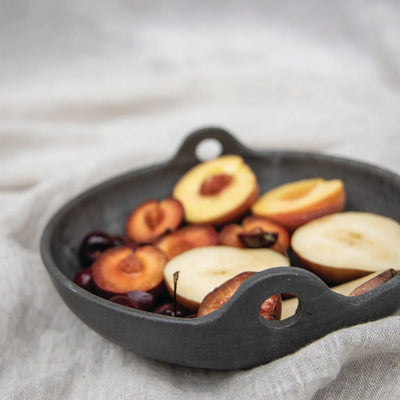 Looped Low Serving Bowl with some cooked fruits by Campfire Pottery on a linen 