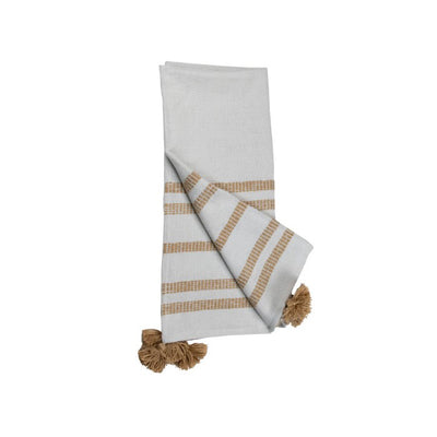 white blanket with beige stripes and beige tassels